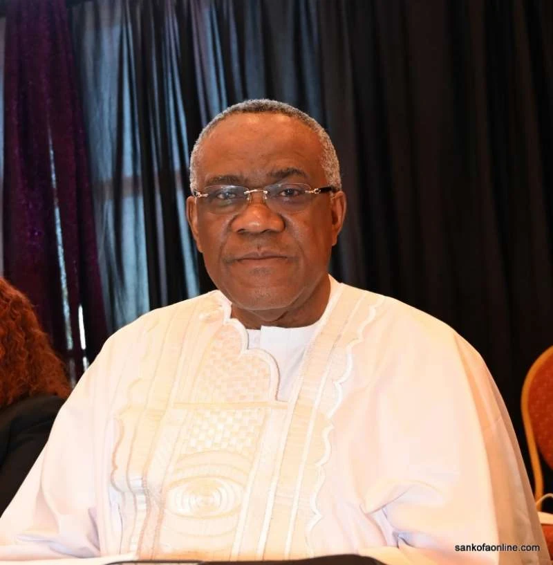 Convention guest wearing white traditional attire